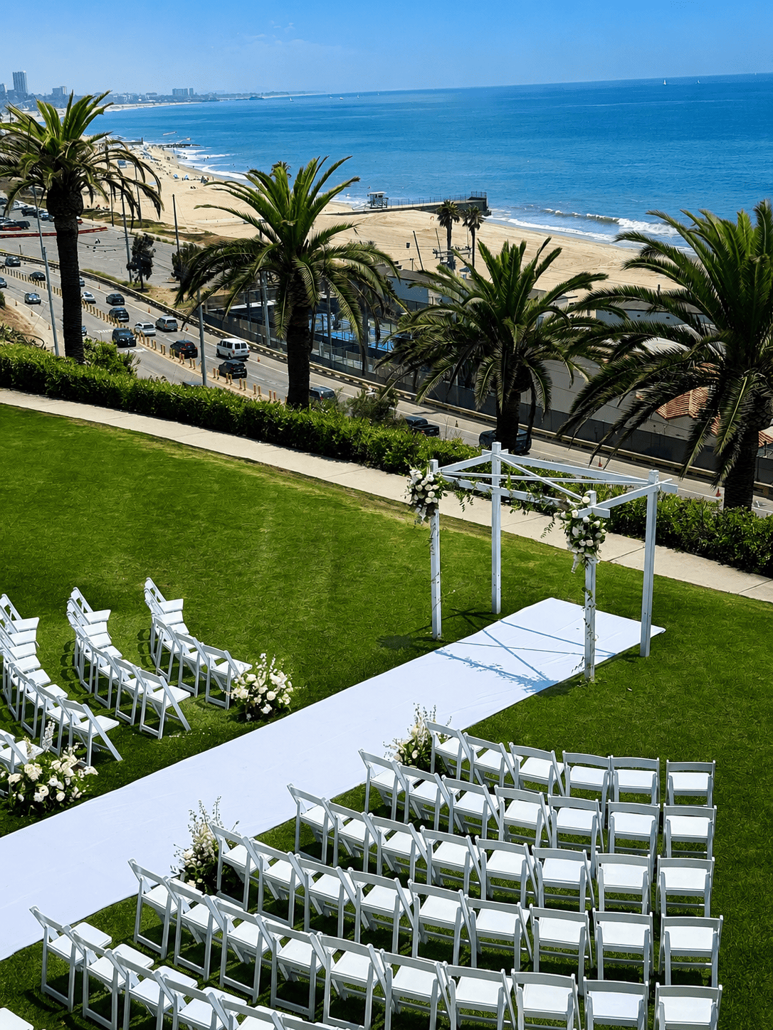 Oceanfront wedding ceremony florals by Casa Dei Fiori