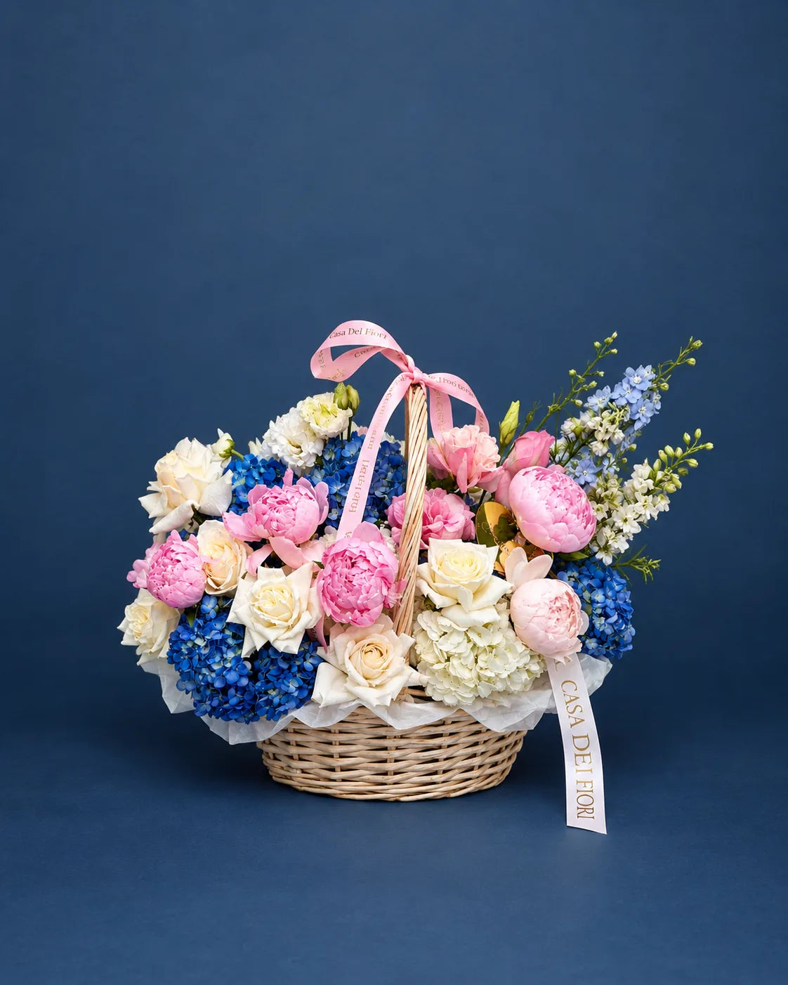 Pink and white peonies with blue hydrangeas in a luxury flower basket by Beverly Hills florist