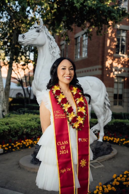 USC graduate wearing a cardinal and gold rose and orchid lei in school colors, graduation lei Los Angeles | Casa Dei Fiori