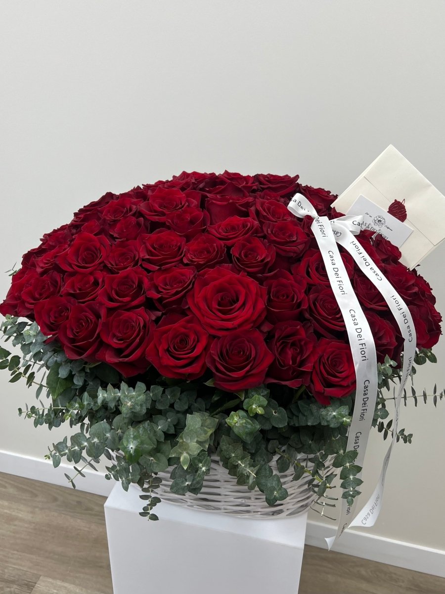 basket with red rose and eucalyptus