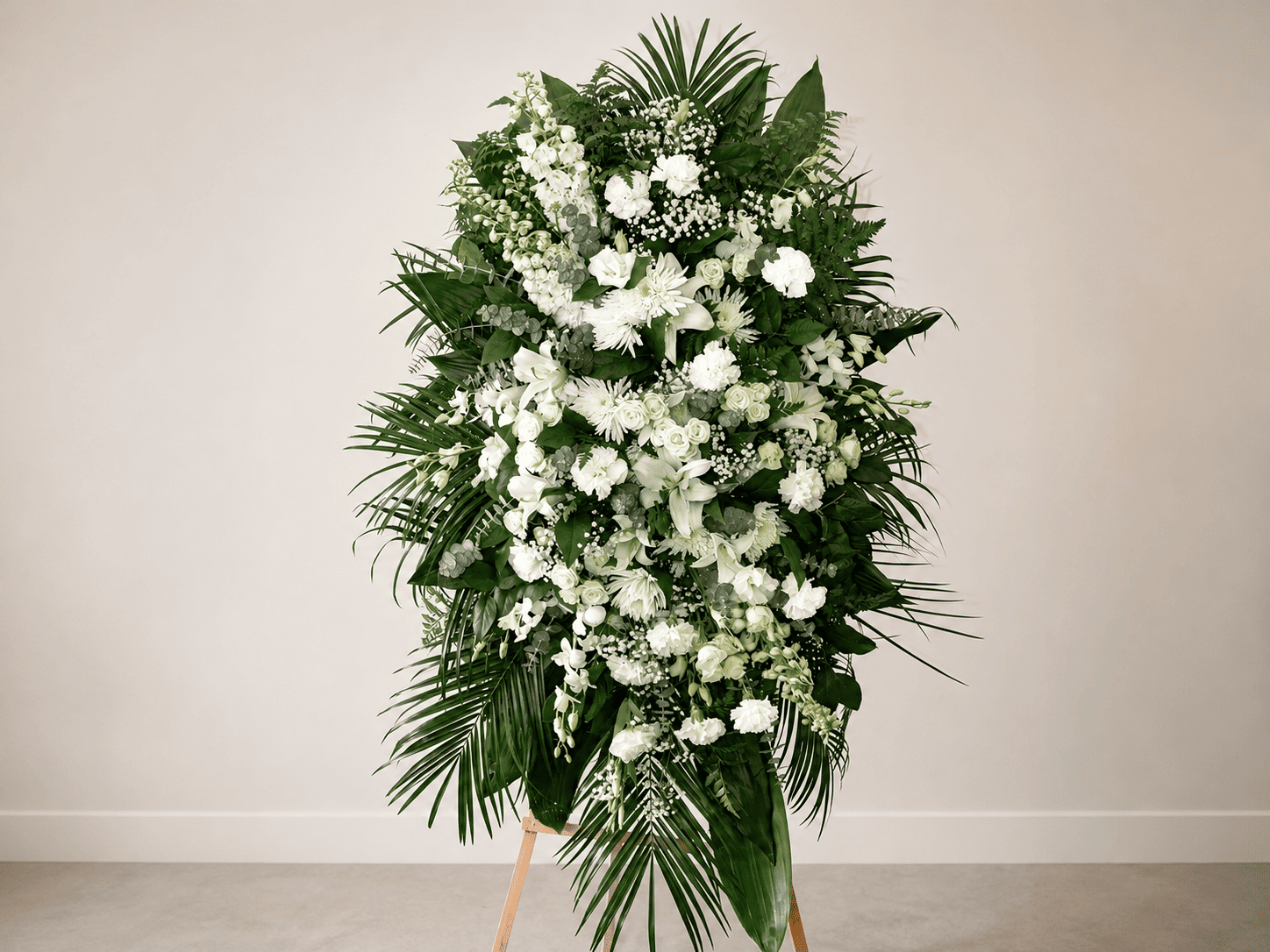 White lily and rose funeral standing spray by Casa Dei Fiori in Beverly Hills