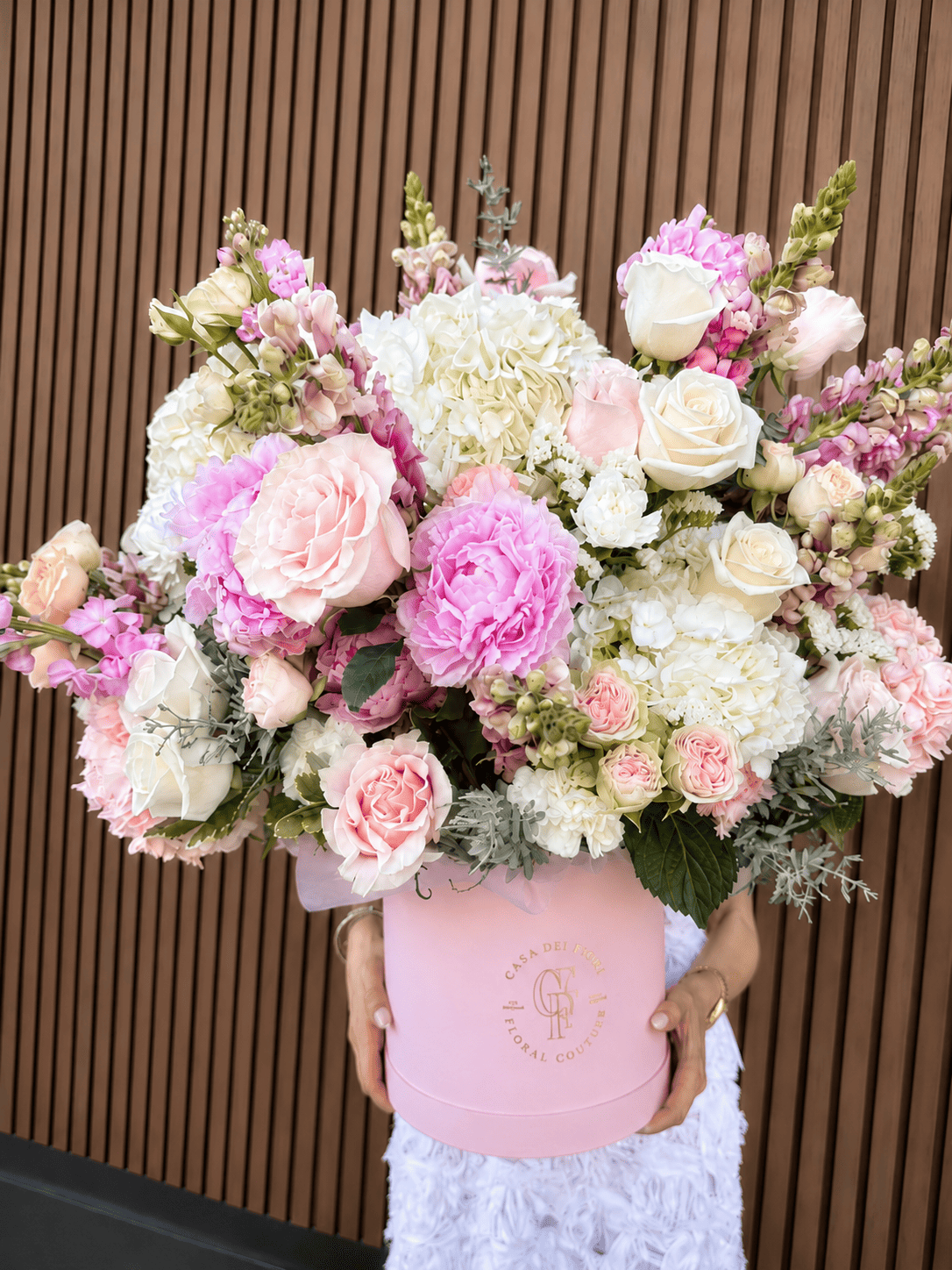 Luxury pink flower arrangement with peonies, garden roses and white hydrangeas in a signature flower box
