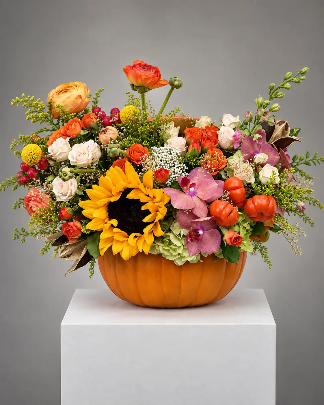 Autumn pumpkin centerpiece with sunflowers, orchids and roses for same-day delivery in Los Angeles