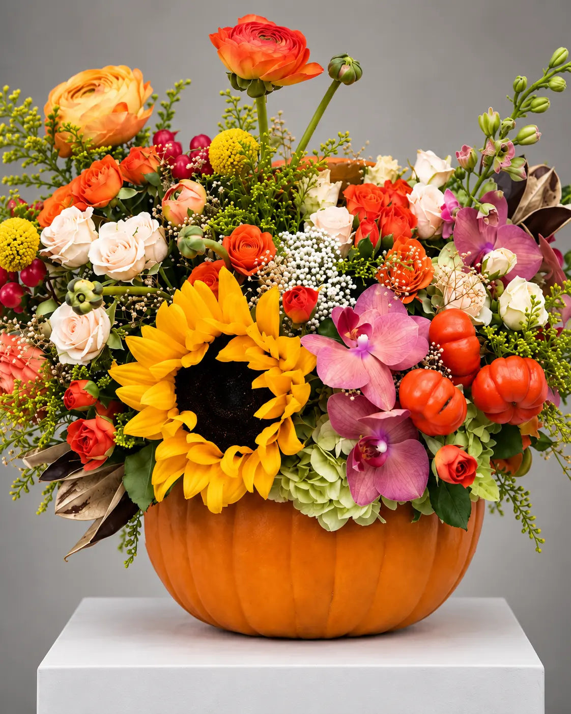 Fall Harvest pumpkin floral arrangement with sunflowers, roses and orchids in Beverly Hills