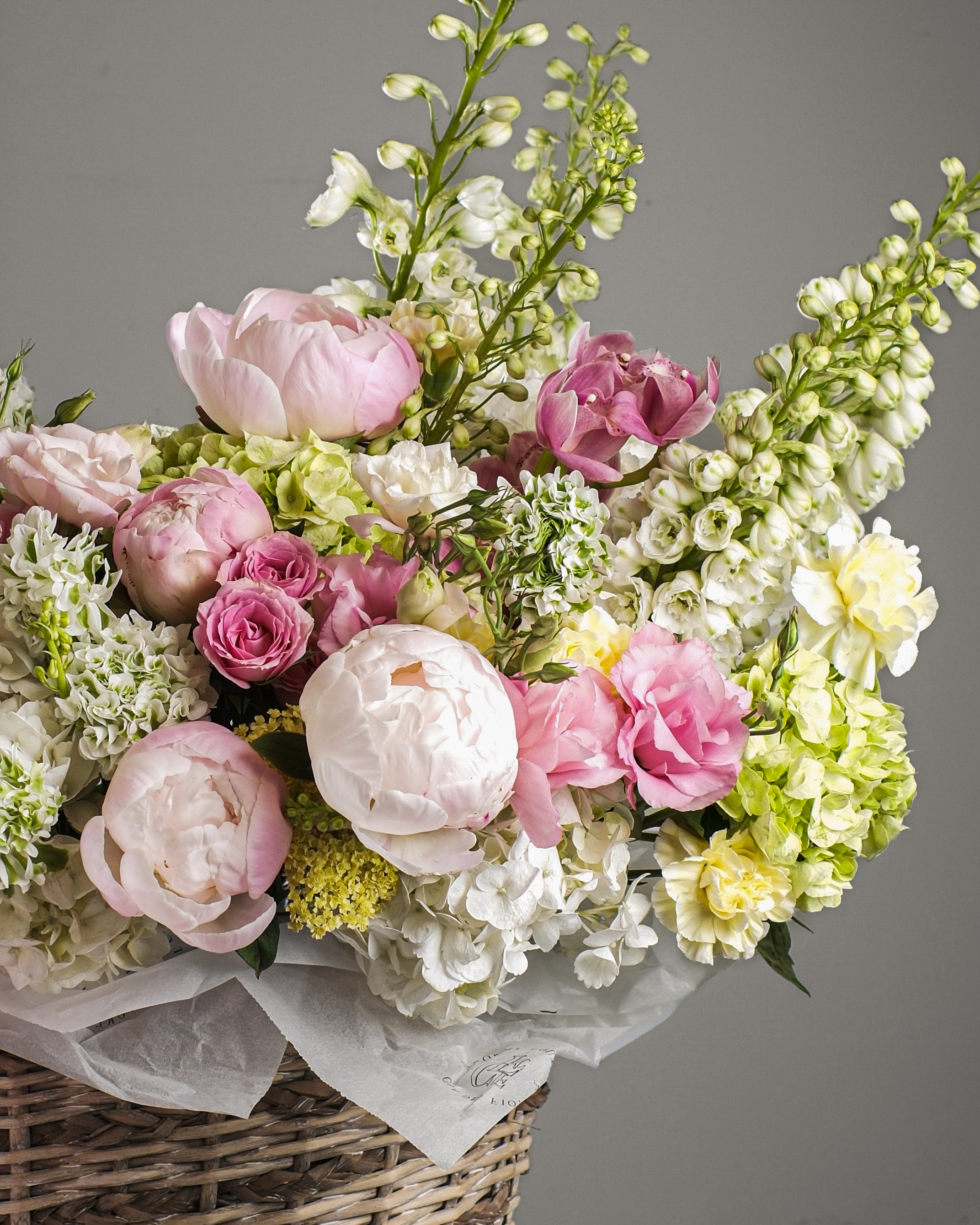 Garden-style basket arrangement with peonies, roses, hydrangea and seasonal flowers in Los Angeles and Beverly Hills