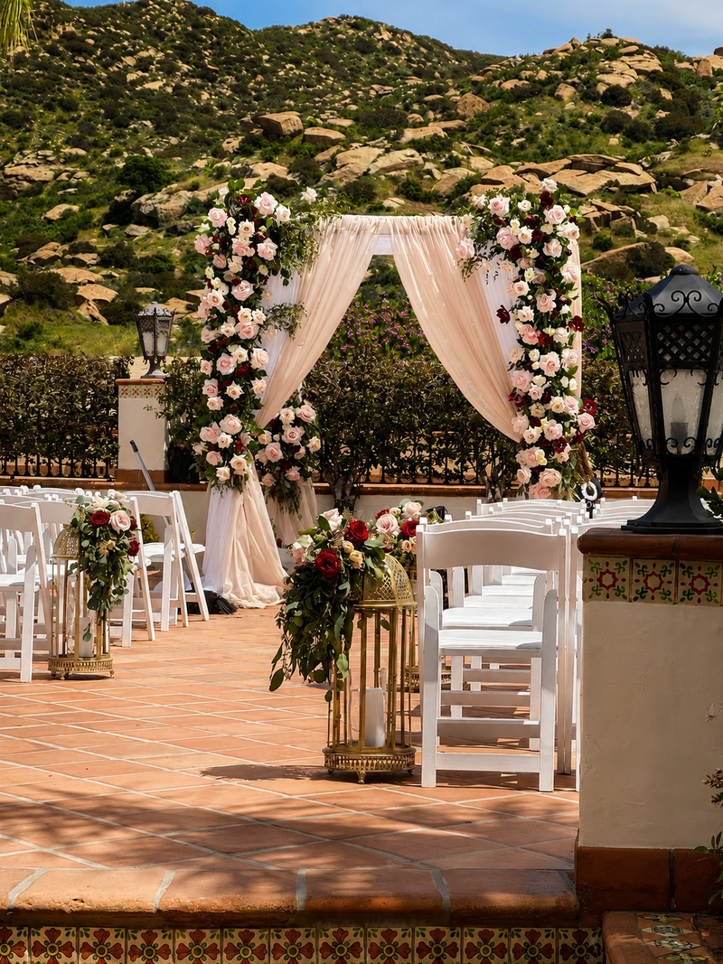Los Angeles florist designing a romantic outdoor wedding ceremony with floral arch and luxury rose arrangements.