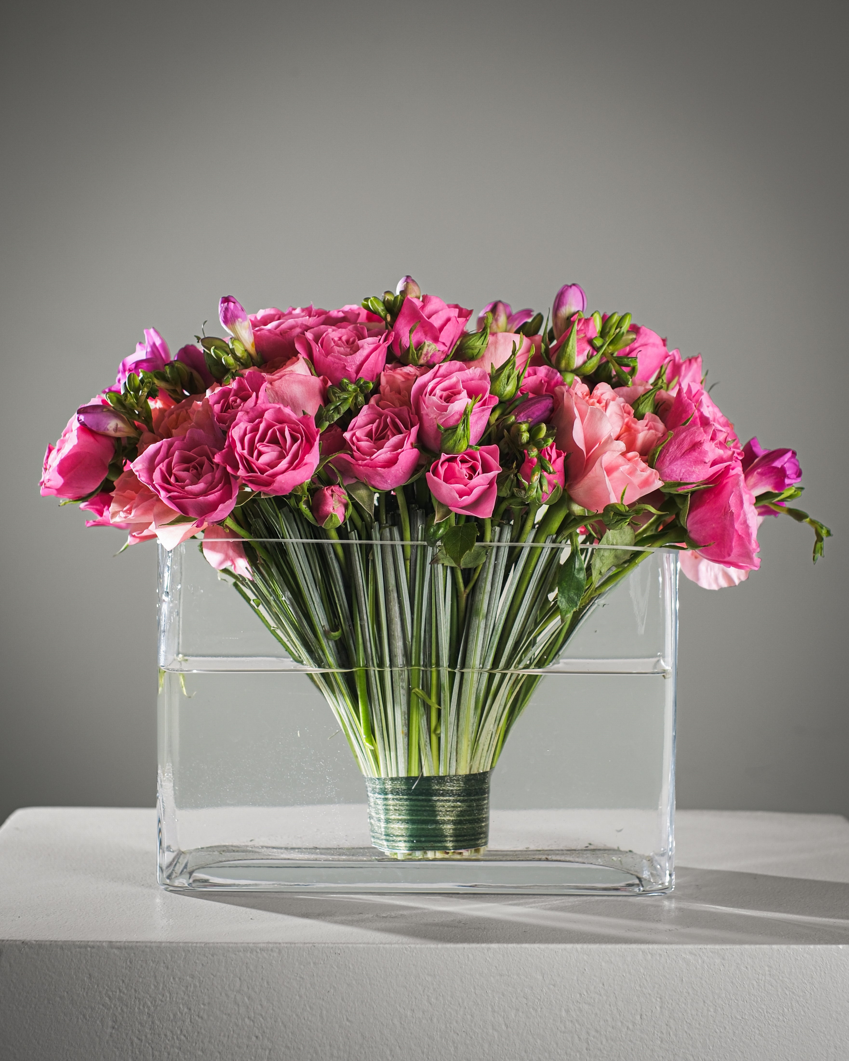 Luxury vase arrangement with pink garden roses, spray roses, freesia and bear grass for flower delivery in Los Angeles and Beverly Hills