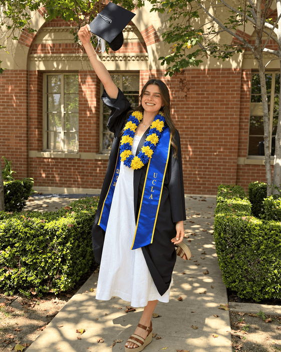 UCLA graduate wearing a blue and gold flower lei in school colors, graduation lei Los Angeles | Casa Dei Fiori