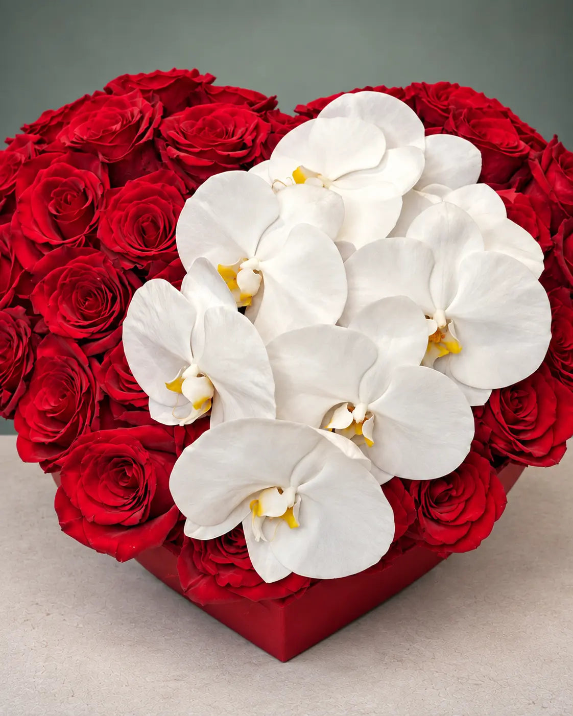 heart-shaped arrangement with red roses and white orchids by Casa Dei Fiori